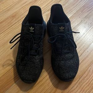Black and gold Adidas sneakers